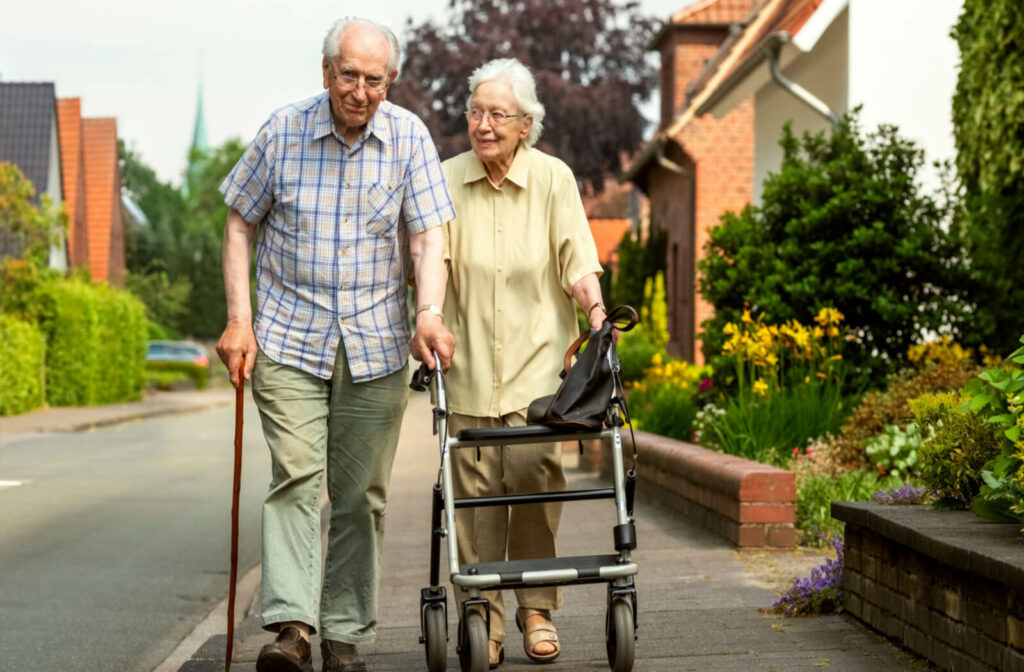 two seniors walk through an independent living facility