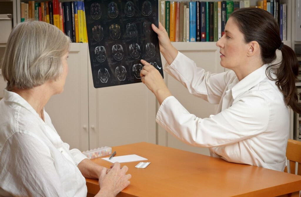 doctor shows a senior woman a brain scan